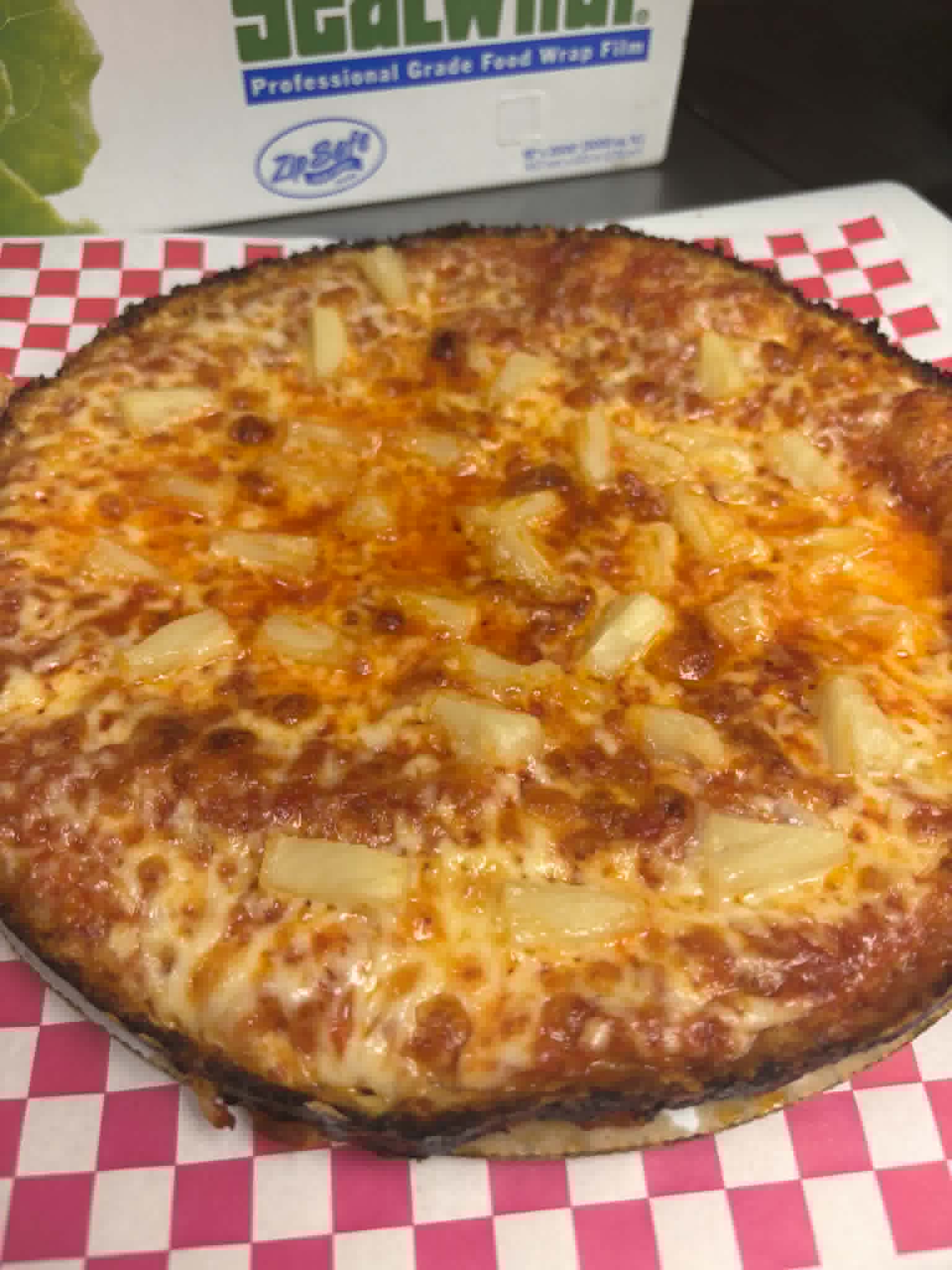 Pineapple pizza with golden melted cheese