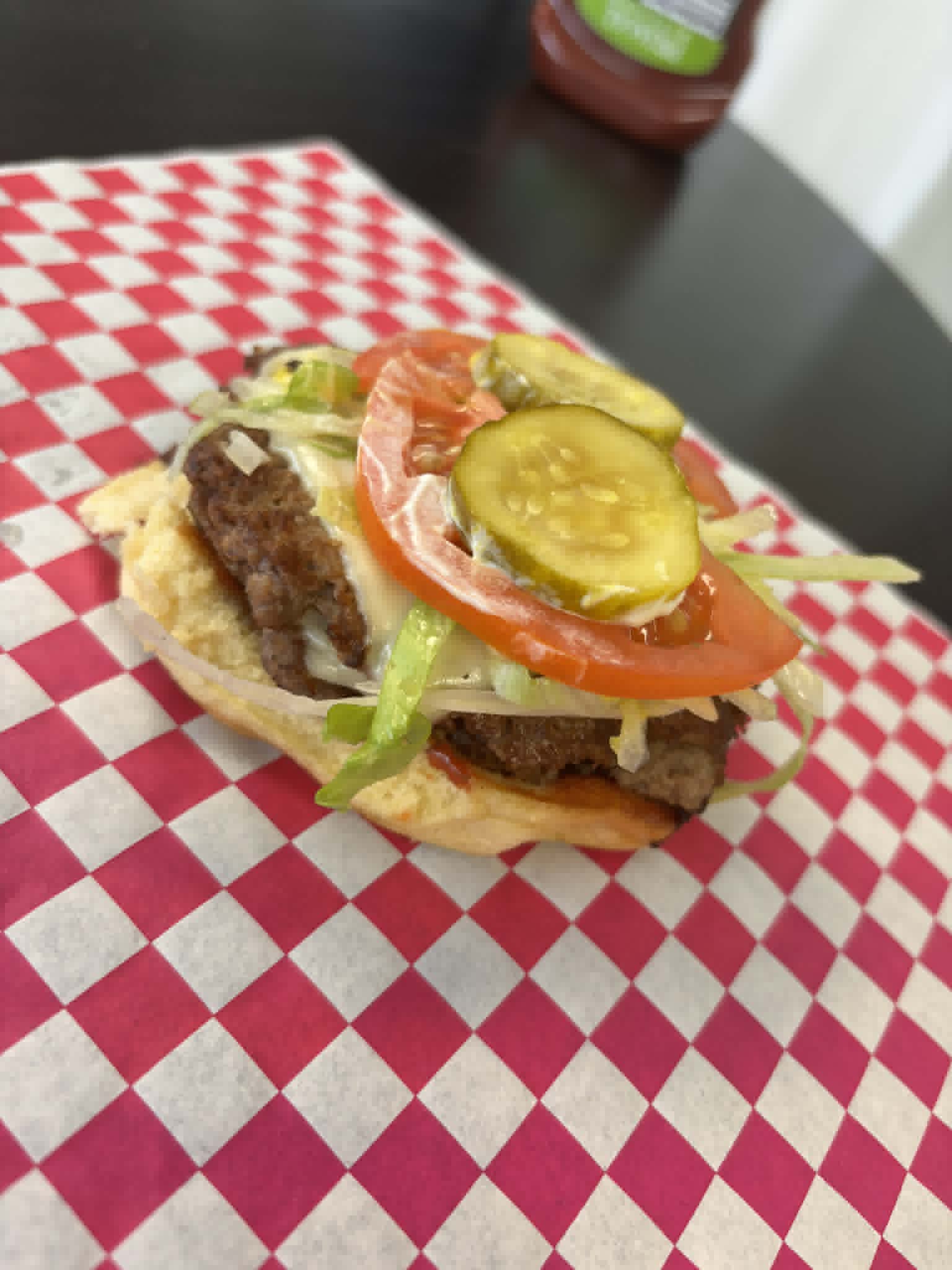 Open-faced smash burger with fresh toppings